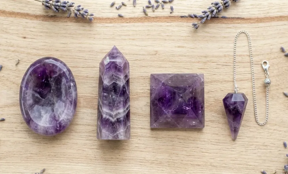 Four crystal formats side by side: worry stone, tower, pyramid and pendulum